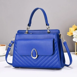 Macro detail of dark blue PU leather bag with quilted pattern and gold hardware