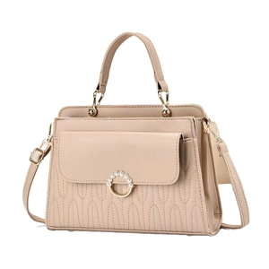 Beige quilted handbag with pearl ring buckle and adjustable shoulder strap on white backdrop