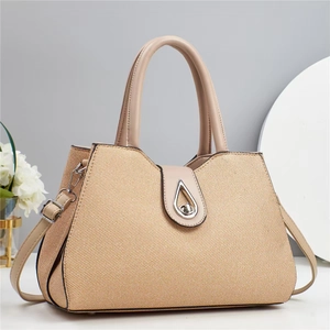 Chic beige woven handbag with tan leather trim and elegant silver teardrop twist lock