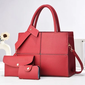 Detailed set of three red lychee grain leather bags including tote and pouch