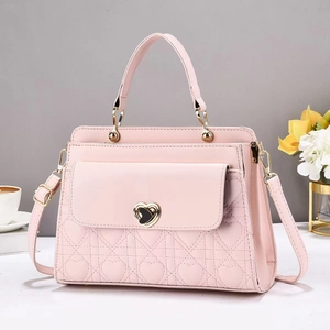Pink heart quilted handbag with metal heart turn-lock and adjustable shoulder strap