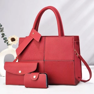 Detailed view of red textured leather 3-piece bag set with vertical stripe stitching pattern