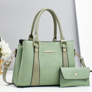 Detail of two-piece grass green handbag set with water ripple texture and gold hardware