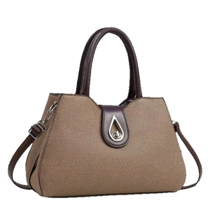 Brown woven tote bag with dark coffee leather trim and silver teardrop metal lock