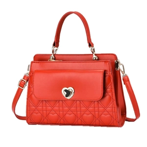 Red quilted leather handbag with heart-shaped gold clasp and adjustable shoulder strap