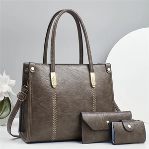 Three-piece tote bag set in coffee faux leather with golden leaf stitching and hardware