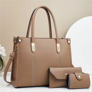 Three-piece women's handbag set in tan pebbled leather with gold hardware and tote strap