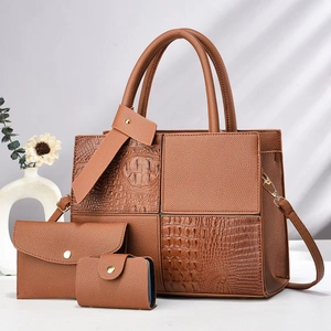 Detailed view of caramel brown three-piece handbag set with crocodile pattern texture