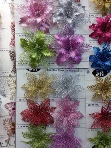 Close-up of assorted hollow glitter Christmas flowers in multiple vibrant colors