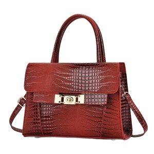 Elegant wine red crocodile pattern handbag with gold hardware and top handle design