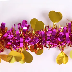 Detail of purple foil tinsel garland with golden heart accents for Valentine decoration