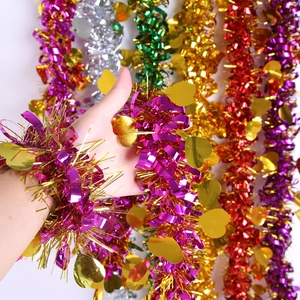 Detail of colorful tinsel garlands with gold heart sequins for festive party decor