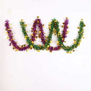 Detail of purple and green festive tinsel garland with gold heart sequins for party decor