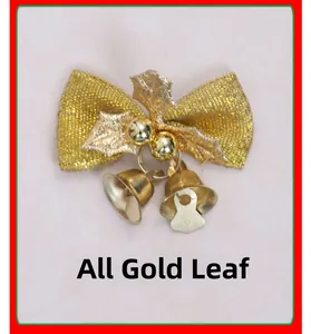Detail of gold Christmas bow featuring glitter holly leaves and metallic bells decoration
