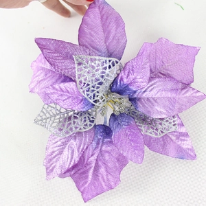 Sparkling purple poinsettia Christmas tree flower with silver glitter hollow leaves