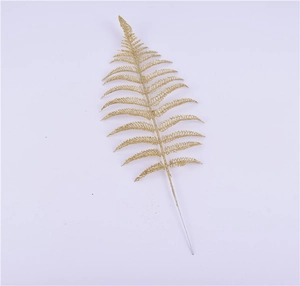 Detail of glitter gold artificial fern leaf for Christmas tree decoration and crafts
