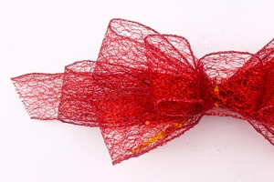 Close-up of red glitter mesh bow showing fine net texture and sparkling festive details