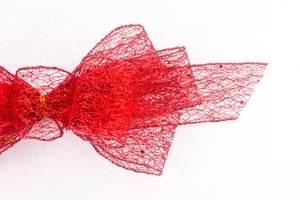 Macro detail of red glitter mesh bow showing intricate translucent mesh and sparkly finish