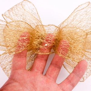 Close-up of golden mesh ribbon with metallic texture and intricate net pattern for crafts