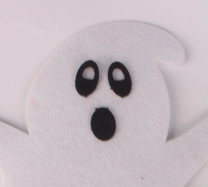 Close-up of white felt ghost pendant with classic cutout eyes for Halloween decor