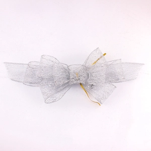 Silver glitter mesh bow decoration for weddings and parties with gold twist tie fastener