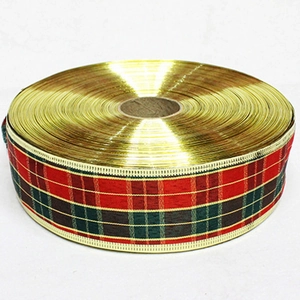 Close-up of red and green Scottish tartan ribbon with gold metallic edges for Christmas DIY