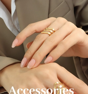 Detail shot of a triple V-shaped gold-plated stainless steel ring on model hand