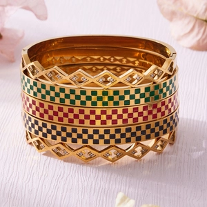 Set of four stackable gold stainless steel bracelets with colorful enamel checkers and zircon