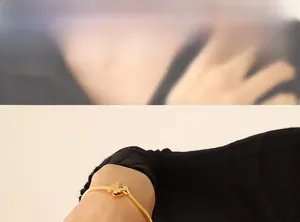 Close-up of elegant gold butterfly bracelet with zircon stone on model wrist