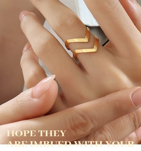 Macro shot of rose gold V-shaped open ring showing sleek geometric lines and polished finish