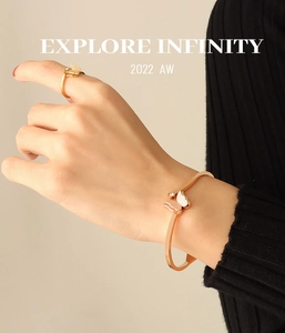 Detail of rose gold butterfly cuff and ring set with frosted texture and zircon stones