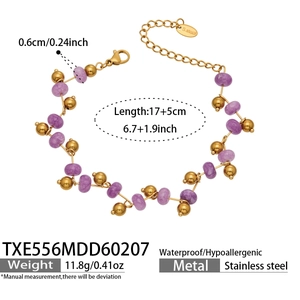 Detail of beaded purple crystal bracelet with gold stainless steel balls and lobster clasp