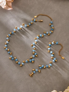 Detail of light blue natural stone beads and gold stainless steel clasp on jewelry set