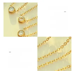 Detail of 18K gold plated titanium necklace featuring a clear cubic zirconia pendant