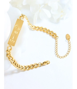 Detailed macro view of gold-plated stainless steel chain with Smile engraving and lobster clasp