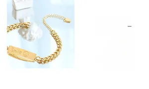 Close-up of 18k gold plated chunky chain bracelet with Smile engraved rectangular plate