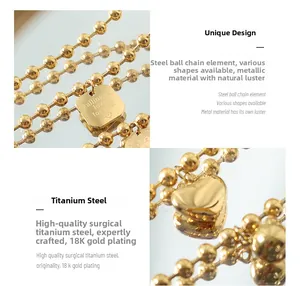 Detailed macro view of 18K gold plated steel bead chain with heart and square pendants