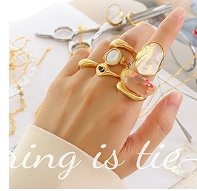 Macro detail of stacking rings with gold finish, shell inlay, and black heart pattern