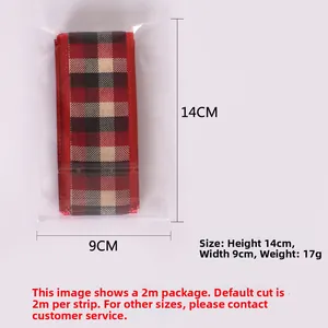 Detail view of red and black plaid Christmas ribbon in clear 14x9cm packaging