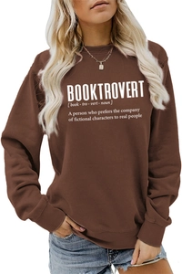 Detail of Booktrovert lettering on a brown long sleeve crewneck sweatshirt for women