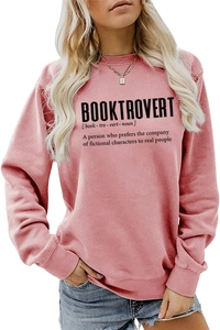 Close-up of Booktrovert text print on pink long sleeve crewneck sweatshirt for women