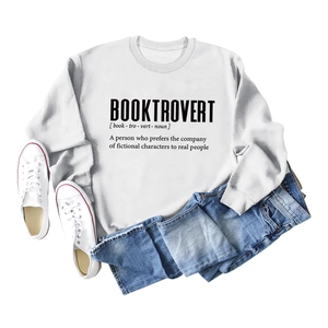 Flat lay of a white long sleeve Booktrovert graphic sweatshirt with casual blue jeans