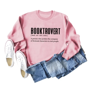 Flat lay of pink Booktrovert long sleeve sweatshirt with denim pants and white sneakers