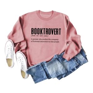 Pink Booktrovert crewneck sweatshirt styled with jeans and white canvas shoes