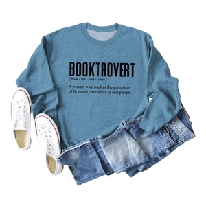 Flat lay of blue Booktrovert sweatshirt with white canvas shoes and blue denim jeans