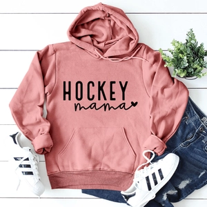 Détail du sweat à capuche rose Hockey mama avec un jean et des baskets blanches