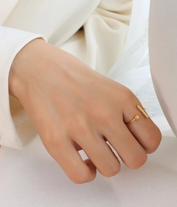 Close-up of minimalist 18k gold plated T-bar open ring on model's finger