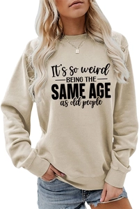 Detail of ribbed cuffs and slogan print on a beige long-sleeved casual sweatshirt
