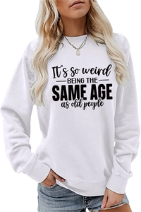 Detail of the white crewneck sweatshirt with It's so weird being the same age slogan print