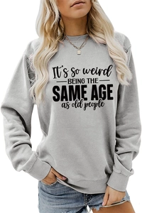 Detail of grey sweatshirt showing the printed text It's so weird being the same age as old people